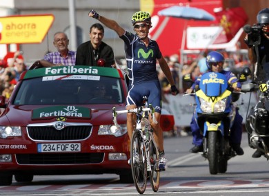 Movistar's Pablo Lastras salutes the crowd as he crosses the line.