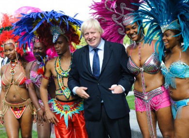 London Mayor Boris Johnson pictured with members of the Genesis Mas band, who will be performing at the Notting Hill Carnival this weekend