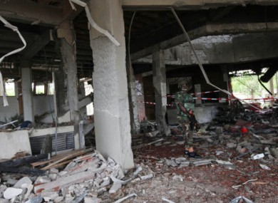 A Nigerian soldier stands in the damaged UN offices after last week's attack.