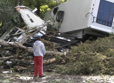 Lauren McTear looks over the remains of the trailer home owned by her boyfriend's parents today in Vermont.
