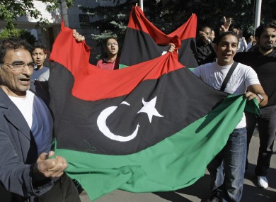 Libyans outside the country's embassy in Moscow, Russia which has now recognised the NTC.