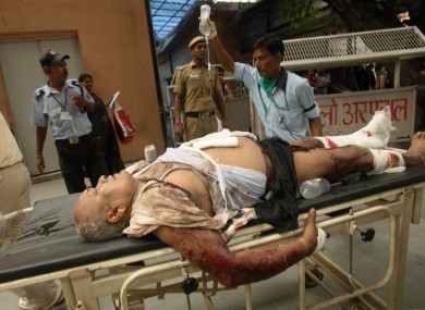 A man injured in this morning's Delhi explosion is rushed to a nearby hospital. At least 9 people have been declared dead after the blast.