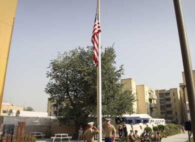 Flags fly at half-mast in the US embassy in Kabul last Sunday. The embassy is among buildings targeted by a Taliban assault today.