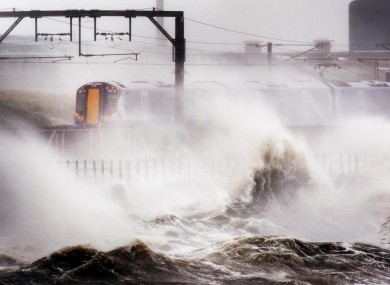 A train continues its journey in North Ayrshire, Scotland amid heavy winds and strong waves brought by Hurricane Katia.