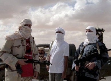 Revolutionary fighters from Sirte guard the western entrance to the city on Thursday.