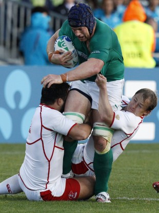 Russia's Valeriy Tsnobiladze, left, and Alexander Yanyushkin tackle Ireland's Sean O'Brien.