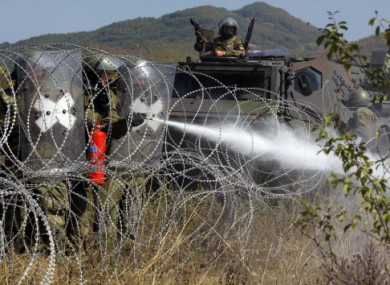German troops of NATO's peacekeeping mission extinguish a fire along the border between Serbia and Kosovo yesterday.