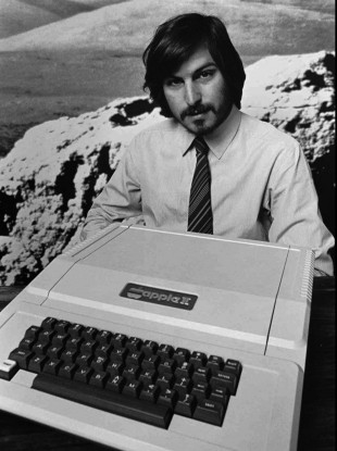This 1977 file photo shows Apple co-founder Steve Jobs as he introduces the new Apple II in Cupertino, California.