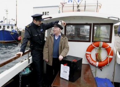 File photo: Garda Ronan McNamara and presiding officer Hugh O'Donald bring a ballot box to Inishfree for the general election.