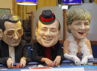 Oxfam activists post as Sarkozy, Berlusconi and Merkel in May 2011.
