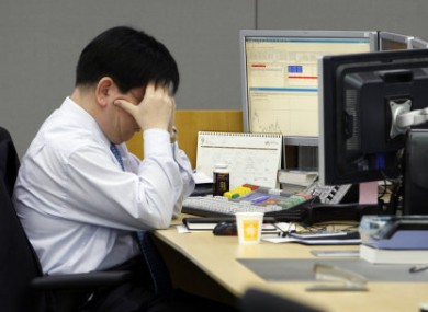 A trader at the foreign exchange room of the Korean Exchange Bank in Seoul reacts to Friday's trading.