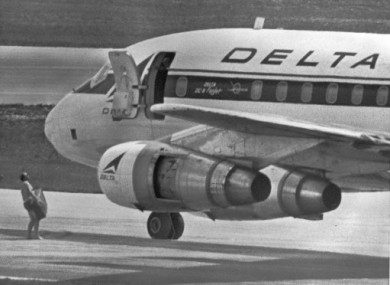 July 1972 file photo of an FBI agent wearing only swim trunks, as per the hijacker's instructions, carrying a $1m ransom to the Delta DC8 plane in Miami. George Wright is wanted in connection with the hijacking.