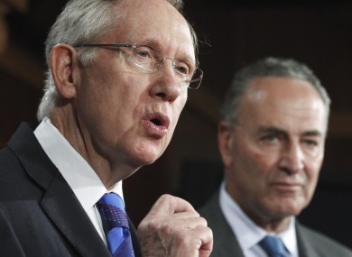 Harry Reid and Charles Schumer address reporters. The Democratic senators have delayed a vote on a bill sanctioning China.