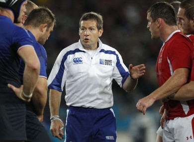 Alain Rolland talks to French and Welsh players ahead of a scrum during their Rugby World Cup semi-final at Eden Park.