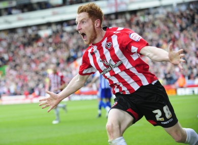 Stephen Quinn celebrates after opening the scoring for Sheffield United against Sheffield Wednesday yesterday. The match finished 2-2.