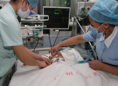 Two-year-old Wang Yue being treated in hospital after she was run over by two vehicles last week.