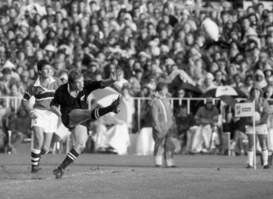 Grant Fox kicks a penalty for New Zealand as Australian referee Kerry Fitzgerald looks on.