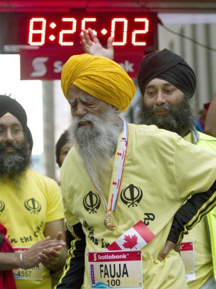 Fauja Singh grimaces after completing the Toronto Waterfront Marathon in over eight hours.