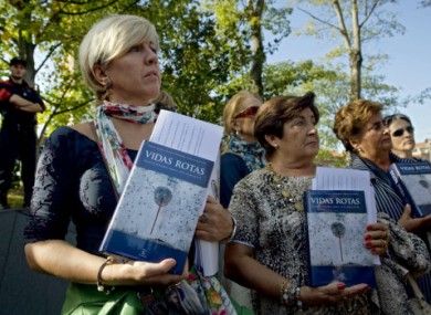 Relatives of people killed by the Basque armed group ETA protest with several books with the history of more than eight hundred people killed by ETA, during the International Conference in San Sebastian, northern Spain on Monday.