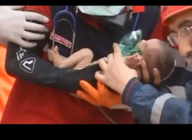 Miracle: two-week-old Azra Karaduman is pulled from the rubble