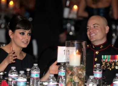 Sgt Scott Moore with his guest, actress Mila Kunis, at the ball on Friday.