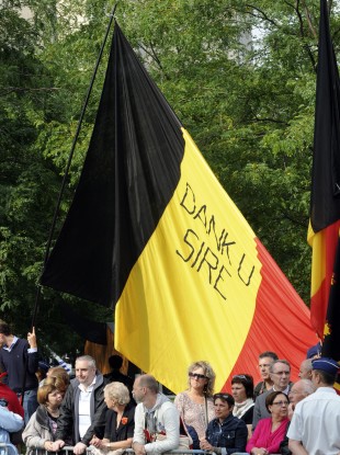 Belgians wave a flag reading 'Thank you, Sir', praising the King for his role in steering the country through its political vacuum.