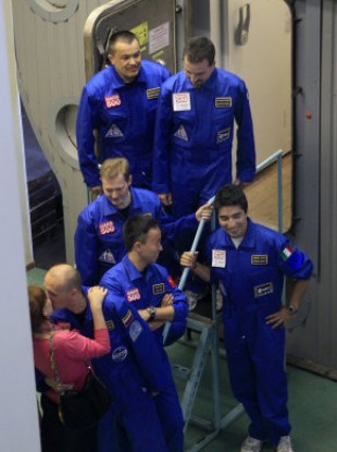 Russia's Alexey Sitev kisses his wife after the group emerges from the Mars500 mission.