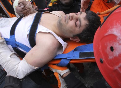 A survivor is pulled from the rubble of the hotel