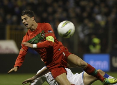 Ronaldo goes down under a challenge from Bosnia's Senad Lulic.