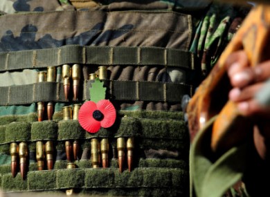 A poppy and bullets on a soldier's jack at British and Afghan troops marked Armistice Day for the first time together today.