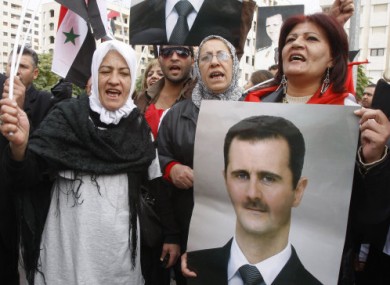 Supporters of President Assad gather outside the Syrian foreign ministry in Damascus yesterday.