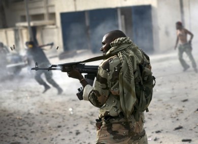 A Liben rebel fighter fires towards Gaddafi loyalists in Sirte, Libya on 19 October.