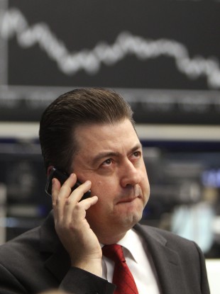 A trader makes a phone call at the stock market in Frankfurt today when the German stock index DAX went down more than two per cent.