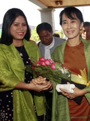 Aung San Suu Kyi, right, pictured yesterday before she officially registered her political party.