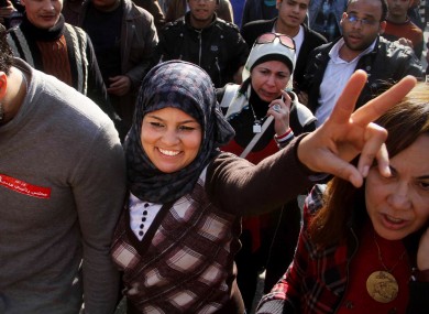 Samira Ibrahim, 25, flashes the victory sign during a rally supporting women's rights in Cairo, Egypt, today. Ibrahim filed a lawsuit against virginity tests after being subjected to a forced 'test'.