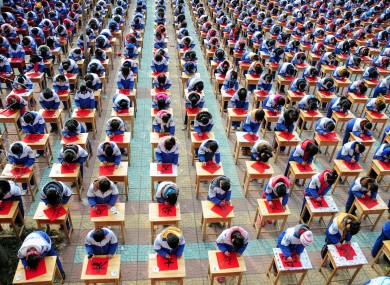Students of No 3 Middle School in Tancheng, China practice their handwriting for the upcoming Year of the Dragon