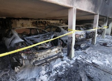 The charred remains of cars in LA yesterday.