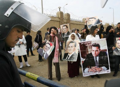 Supporters of former Egyptian leader Hosni Mubarak hold a rally outside a Cairo courthouse where Mubarak's trial resumed today.
