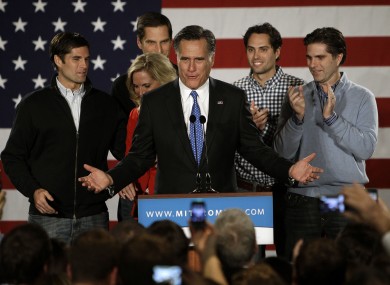 Romney, flanked by his wife and sons, at a 'victory' rally in Des Moines, Iowa last night.
