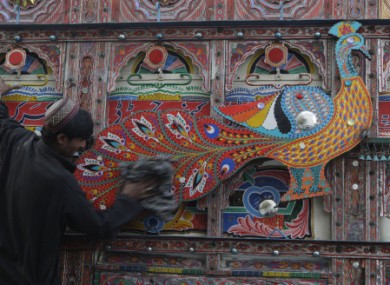 A truck driver cleans his vehicle in Lahore, Pakistan.