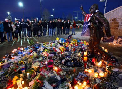A crowd gathers to pay respects to longtime football coach Joe Paterno at his statue outside Beaver Stadium.