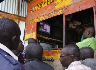 People follow ICC proceedings in Nairobi yesterday as pre-trial judges order four Kenyans to stand trial.