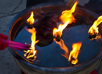 Chinese worshippers light joss sticks to pray for prosperity and well being at the Dongyue Temple during the Chinese New Year in Beijing, China.