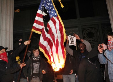 Occupy Oakland protestors burn an American flag found inside Oakland City Hall during an Occupy Oakland protest on the steps of City Hall on Saturday