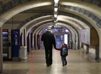 A man and a child walk through an empty hallway of Belgium's second busiest train station in Ghent this morning. The country has been effectively shut down by a general strike.