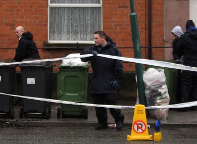 Garda and forensic officers at the scene off Blackhorse Avenue in Dublin, where the body of a woman was found murdered and dumped on the street in a suitcase.
