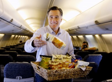Mitt Romney throws bags of potato chips at reporters travelling with his campaign in Florida yesterday.