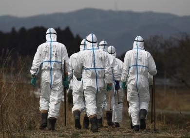 Police officers in Fukushima last April wearing suits to protect them from radiation