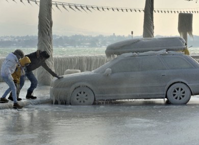 A frozen car parked by Lake Geneva in Versoix, Switzerland.