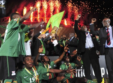 Former Zambian president, Kenneth Kuanda celebrates with the trophy.